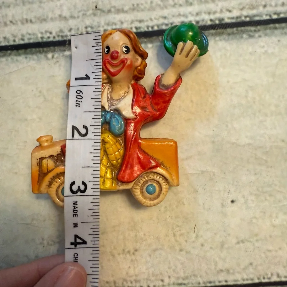 Vintage clown figurine riding in a car. Made in Japan.